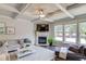 Comfortable living room featuring a coffered ceiling, fireplace, and large windows at 3049 Ivy Crossing Dr, Buford, GA 30519