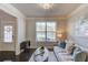 Stylish living room featuring hardwood floors, large window, and comfortable sofa at 3049 Ivy Crossing Dr, Buford, GA 30519