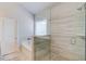 Modern glass shower with neutral tile, a shower head, and soaking tub at 3049 Ivy Crossing Dr, Buford, GA 30519