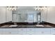 Bathroom showcasing double vanity, large mirror, and granite countertop at 4890 Revere Way, Cumming, GA 30028