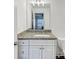 Bathroom with a granite countertop, white cabinets, and neutral walls at 4890 Revere Way, Cumming, GA 30028
