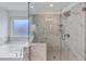 Bathroom featuring a shower with glass enclosure, soaking tub, and window at 4890 Revere Way, Cumming, GA 30028