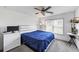 A simple bedroom with white walls, gray carpet, and ceiling fan at 4890 Revere Way, Cumming, GA 30028