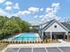 The community pool features a zero entry, comfortable lounge chairs, and beautiful landscaping for relaxation and social gatherings at 4890 Revere Way, Cumming, GA 30028