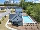 The neighborhood pool is surrounded by lounge chairs, trees and other neighborhood homes, offering a refreshing escape and relaxation at 4890 Revere Way, Cumming, GA 30028