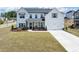 Beautiful two-story home showcasing a large lawn, attached garage, and classic architecture under a sunny sky at 4890 Revere Way, Cumming, GA 30028