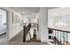 Bright hallway features neutral walls, carpeted floors, and elegant staircase with iron spindles at 4890 Revere Way, Cumming, GA 30028