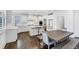 Bright, white kitchen boasts an island, modern appliances, and space for a large dining table at 4890 Revere Way, Cumming, GA 30028