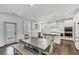Modern kitchen with white cabinets, stainless steel appliances, a center island, and a casual dining area at 4890 Revere Way, Cumming, GA 30028