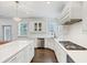 Modern kitchen featuring white cabinets, stainless steel appliances, and a center island at 4890 Revere Way, Cumming, GA 30028