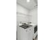 Laundry room with white appliances, white walls, and a wire shelf at 4890 Revere Way, Cumming, GA 30028