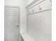 Mudroom area features built-in bench and coat hooks at 4890 Revere Way, Cumming, GA 30028