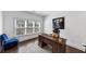 Office with a wooden desk, comfortable chair, and modern decor at 4890 Revere Way, Cumming, GA 30028