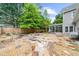 Backyard with flagstone patio, unique rock detail, and screened-in porch at 230 Bristolstone Ct, Alpharetta, GA 30005