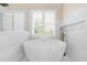 This bathroom features a standalone tub, updated fixtures, and tile surround at 230 Bristolstone Ct, Alpharetta, GA 30005