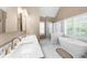 This bathroom features double sinks, a standalone tub, and a glass shower at 230 Bristolstone Ct, Alpharetta, GA 30005