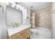 Modern bathroom with marble countertop vanity, tub, shower with gold hardware, and stylish tile at 230 Bristolstone Ct, Alpharetta, GA 30005