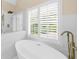 This bathroom features a standalone tub, updated fixtures, and tile surround at 230 Bristolstone Ct, Alpharetta, GA 30005