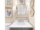 Bright bathroom with a modern gray vanity, white countertop, framed ocean art, and stylish fixtures at 230 Bristolstone Ct, Alpharetta, GA 30005