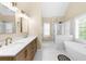 Bright bathroom with double vanity, soaking tub, and glass shower at 230 Bristolstone Ct, Alpharetta, GA 30005