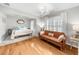 Bright bedroom featuring white walls, hardwood floors, a bed, a leather couch, and recessed lighting at 230 Bristolstone Ct, Alpharetta, GA 30005