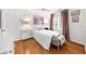 Bright bedroom with white walls and hardwood floors, featuring a single bed, stylish decor, and natural light at 230 Bristolstone Ct, Alpharetta, GA 30005