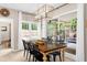 Bright dining room featuring neutral paint, a modern chandelier, and a dining table with six chairs overlooking a sun room at 230 Bristolstone Ct, Alpharetta, GA 30005