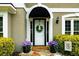 Charming front door with wreath, side lights, lush landscaping, and stone walkway enhancing curb appeal at 230 Bristolstone Ct, Alpharetta, GA 30005
