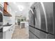 Modern kitchen with stainless steel appliances, quartz countertops, white cabinets and a refrigerator at 230 Bristolstone Ct, Alpharetta, GA 30005