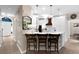 Bright kitchen featuring a breakfast bar with seating and white cabinetry, pendant lighting, and stainless appliances at 230 Bristolstone Ct, Alpharetta, GA 30005