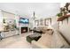 Bright living room featuring a fireplace, tv, couches, chandelier, and a decorative clock on an end table at 230 Bristolstone Ct, Alpharetta, GA 30005