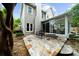 Back of home featuring screened-in porch and stone patio with bench at 230 Bristolstone Ct, Alpharetta, GA 30005