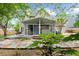 Backyard view with screened-in porch and stone patio at 230 Bristolstone Ct, Alpharetta, GA 30005
