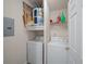 Efficient laundry room featuring a washer, dryer, and water heater on shelving above at 2700 Pine Tree Ne Rd # 1214, Atlanta, GA 30324