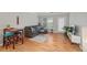 Inviting living room with hardwood floors, gray sofa, natural light, and access to an outdoor patio at 2700 Pine Tree Ne Rd # 1214, Atlanta, GA 30324