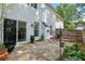 Backyard featuring a stone patio, wooden fence, and sliding glass door at 3303 Timbercreek Cir, Roswell, GA 30076