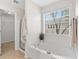 Bright bathroom featuring tiled floors, a tub and access to the walk-in closet at 3303 Timbercreek Cir, Roswell, GA 30076