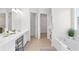Bright bathroom with a vanity, a makeup station, and an entrance to the walk-in closet at 3303 Timbercreek Cir, Roswell, GA 30076