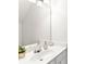 Close-up on bathroom vanity with white cabinets, a light countertop, and decorative accents at 3303 Timbercreek Cir, Roswell, GA 30076