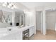Bright bathroom with double vanity, a makeup station, and an entrance to the walk-in closet at 3303 Timbercreek Cir, Roswell, GA 30076