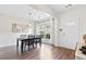 Bright dining room features a modern chandelier, large windows, and hardwood floors at 3303 Timbercreek Cir, Roswell, GA 30076