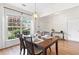 Dining area featuring a wooden table, seating for four, and large windows at 3303 Timbercreek Cir, Roswell, GA 30076