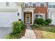 Inviting front entrance showcasing a well-lit porch, green wreath, and neatly trimmed bushes at 3303 Timbercreek Cir, Roswell, GA 30076