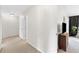 Hallway featuring neutral walls and floors, with a cabinet and open doorway to a bedroom at 3303 Timbercreek Cir, Roswell, GA 30076