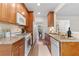 Galley kitchen boasts granite counters, wooden cabinets and modern appliances at 3303 Timbercreek Cir, Roswell, GA 30076