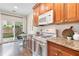 Cozy kitchen featuring granite countertops, a gas range, and convenient access to the outdoor patio at 3303 Timbercreek Cir, Roswell, GA 30076