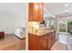 Well-lit kitchen offering wood cabinets, granite countertops, and seamless access to the living space at 3303 Timbercreek Cir, Roswell, GA 30076