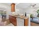 Partial kitchen view, wooden cabinets, granite counters, and open to the dining area at 3303 Timbercreek Cir, Roswell, GA 30076