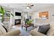 Comfortable living room featuring a fireplace, large windows, and direct access to the kitchen at 3303 Timbercreek Cir, Roswell, GA 30076