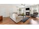 Bright living room featuring a fireplace, wood floors, ceiling fan, and comfortable seating at 3303 Timbercreek Cir, Roswell, GA 30076